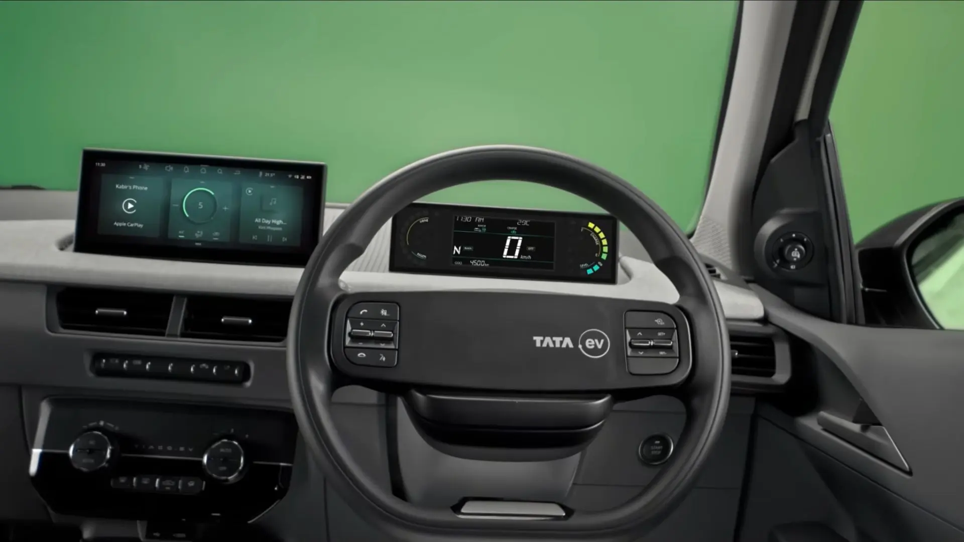 Steering Wheel, Instriment Cluster and Infotainment system of the new Tata Tiago EV. Cruise control button on the right side steering controls is visible.