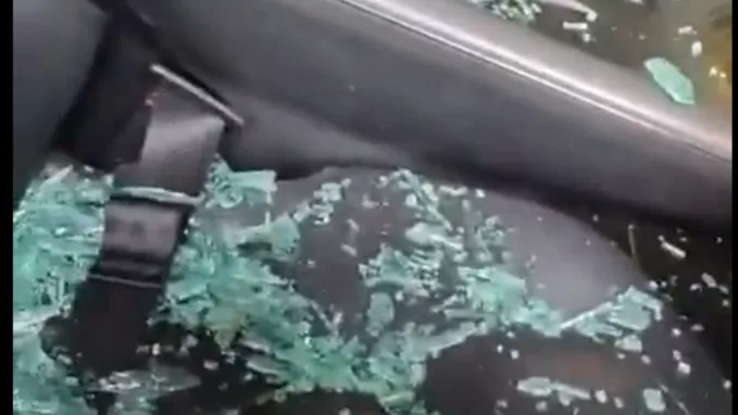 The seatbelt is seen to be buckled when the driver side window glass is broken.